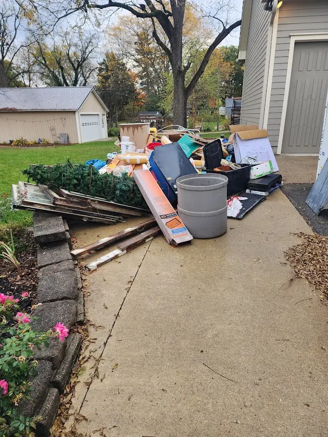 Dumpster being loaded with debris for Commercial Dumpster Rental in Van Buren
